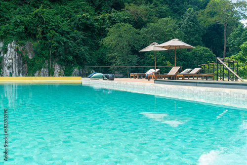 bed pool with umbrella around swimming pool