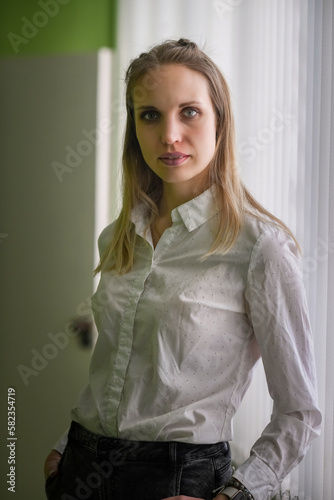 Portrait of a young beautiful blonde girl in an interior studio.