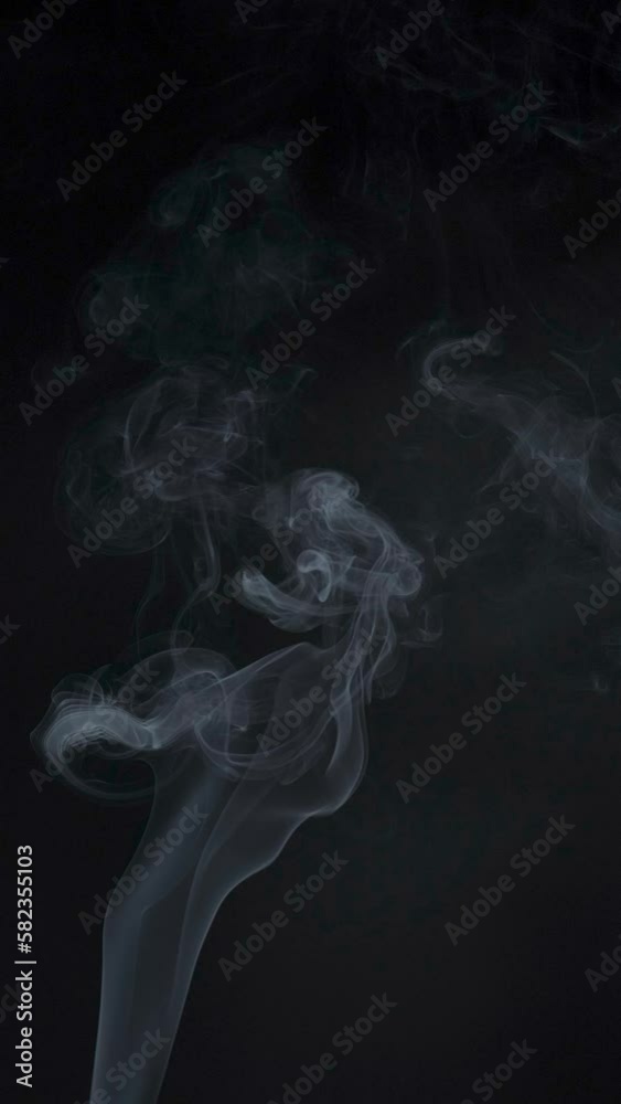 Slow motion vertical video of white smoke, fog, mist, vapor on a black background. Slow motion vertical video of white smoke, fog, mist, vapor on a black background.