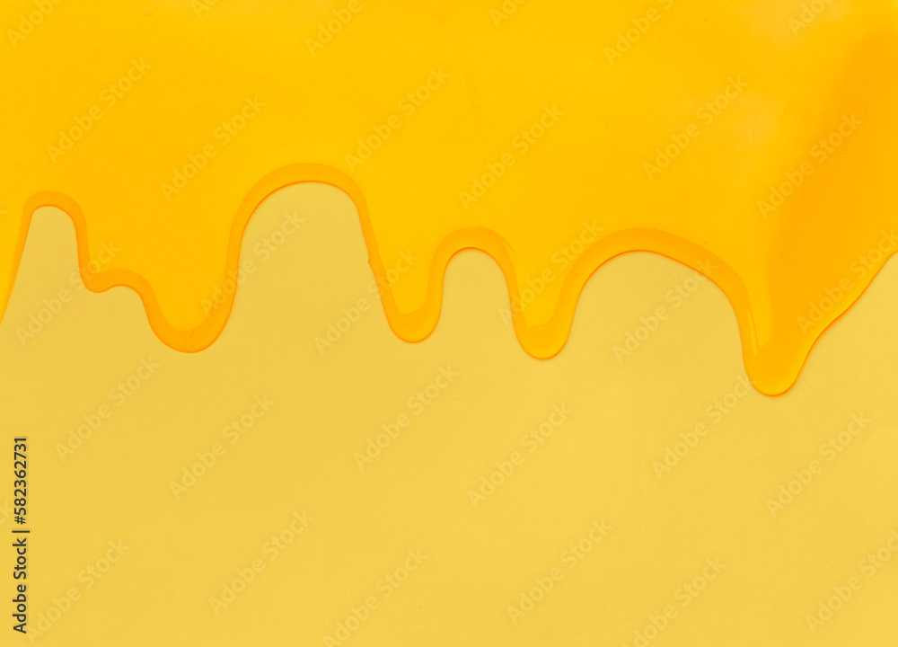 Pouring honey on a yellow background. Pouring honey on a yellow background.