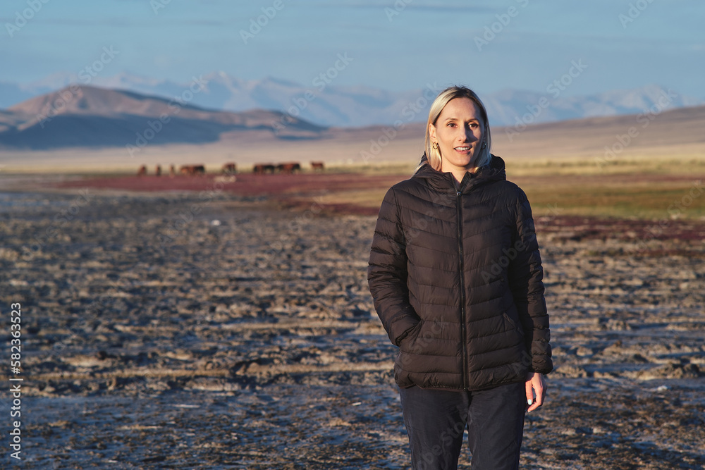 Blonde woman walking early morning at Tuz Kol Lake Blonde woman walking early morning at Tuz Kol Lake