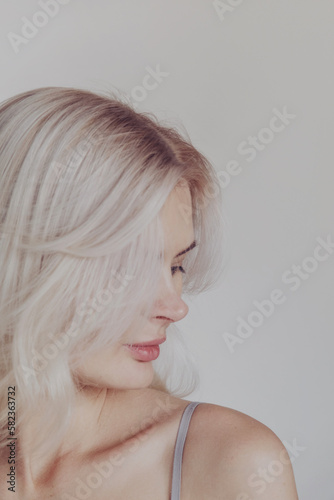 Blond woman portrait at home, healthy hair
