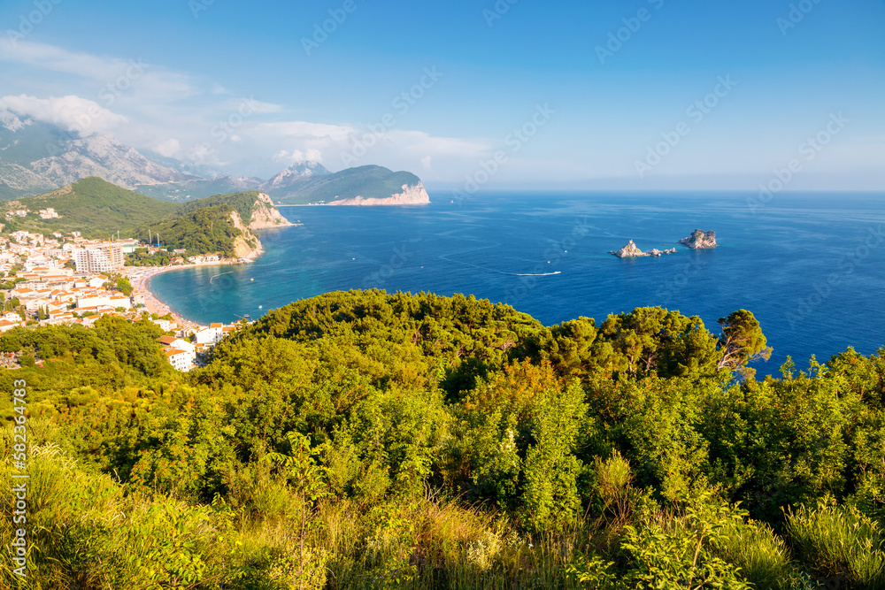 Scenic view of the Adriatic Sea and green coast on a sunny day. Petrovac na Moru, Montenegro, Europe.