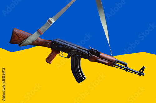 Kalashnikov gun against colors of Ukrainian flag
