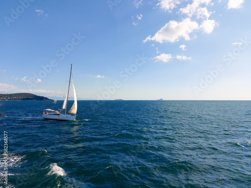 The yacht sails on the high seas in clear weather