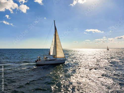 The yacht sails on the high seas in sunny weather