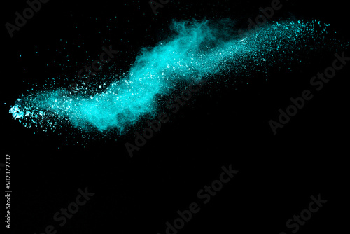 Splash of green colored powder on black background.Green powder explosion.