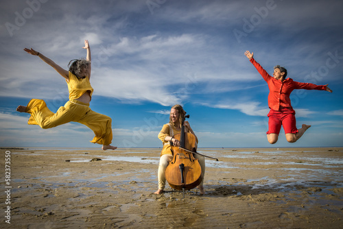 dancers and cellist performing on Cape Cod beach photo