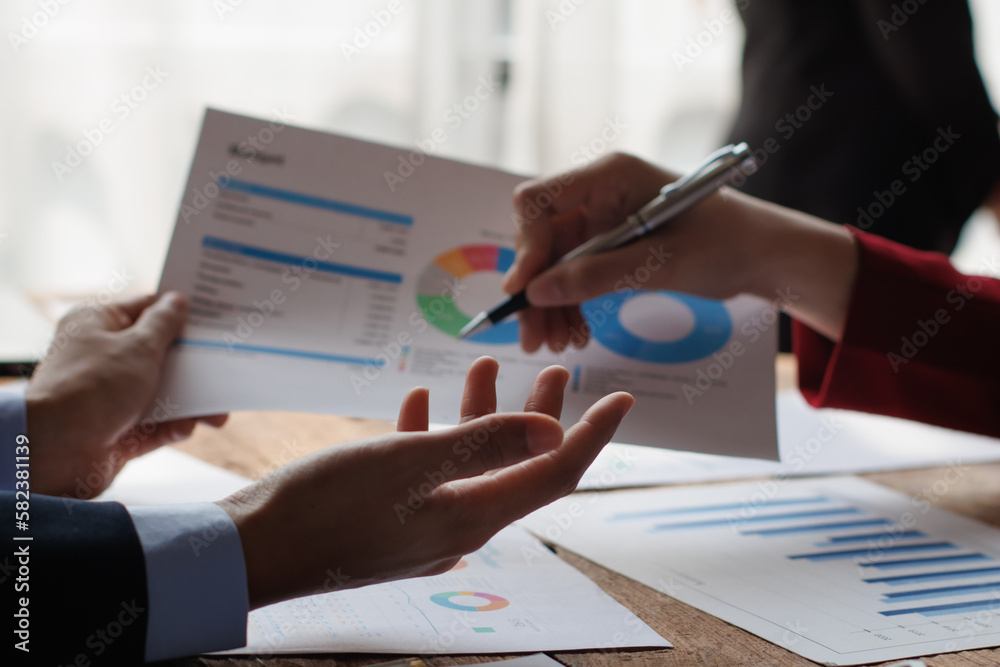 Teamwork with businessman analyzing cost graphs on table at conference room. Teamwork with businessman analyzing cost graphs on table at conference room.