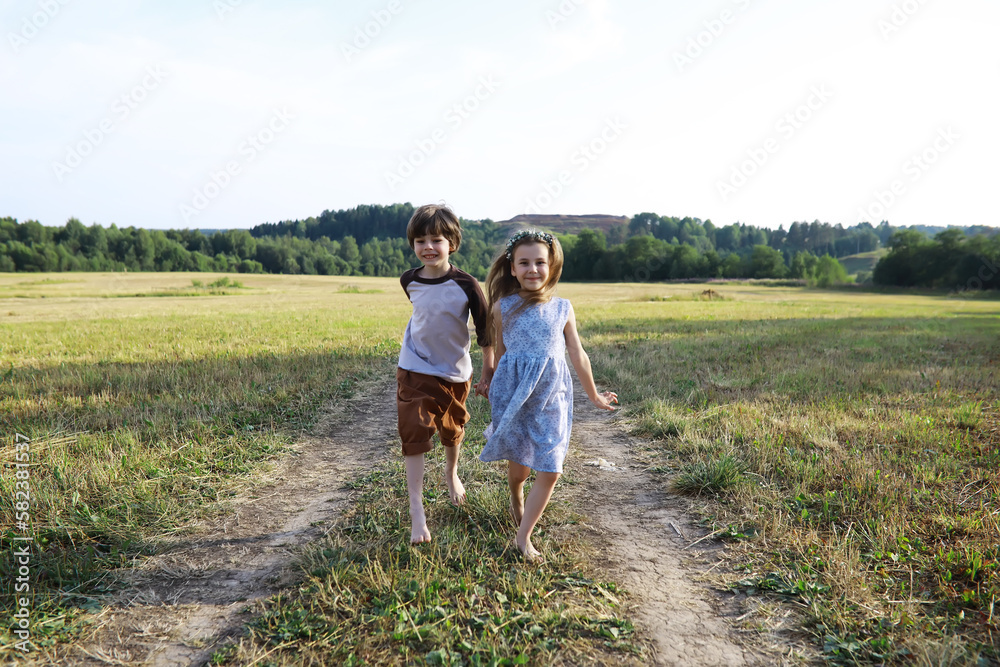 Children walk in the summer in nature. Child on a sunny spring morning in the park. Traveling with children. Children walk in the summer in nature. Child on a sunny spring morning in the park. Traveling with children.