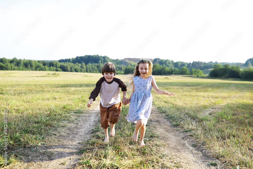 Children walk in the summer in nature. Child on a sunny spring morning in the park. Traveling with children. Children walk in the summer in nature. Child on a sunny spring morning in the park. Traveling with children.