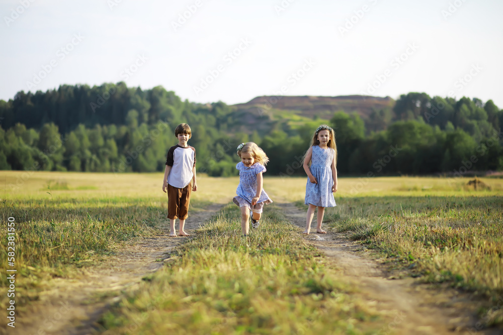 Children walk in the summer in nature. Child on a sunny spring morning in the park. Traveling with children. Children walk in the summer in nature. Child on a sunny spring morning in the park. Traveling with children.