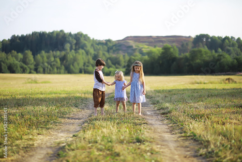 Children walk in the summer in nature. Child on a sunny spring morning in the park. Traveling with children.