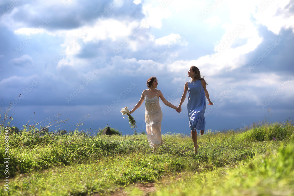 Young girls are walking in the field Young girls are walking in the field