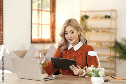 Young woman using laptop comfortably at home