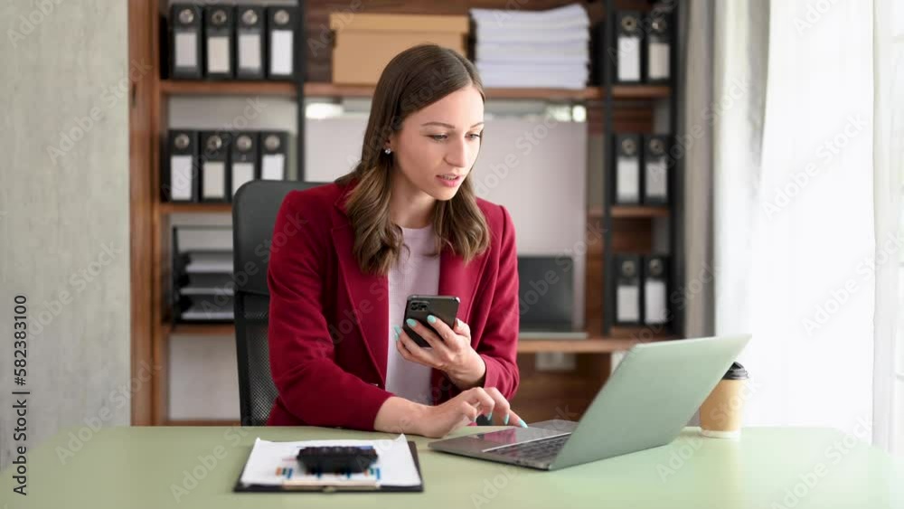 Young beautiful woman using laptop and tablet while sitting at her working place. Concentrated at work... Young beautiful woman using laptop and tablet while sitting at her working place. Concentrated at work...