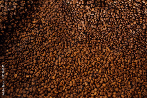 Closeup top view textured background full frame heap of brown roasted aromatic delicious coffee grains