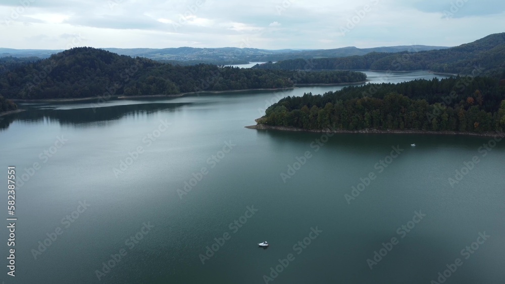 Aerial scenic view of the lake Solina, Jezioro Solińskie, the biggest dam in Poland in autumn at sunset. Recreational area for sail and holidays in the national park of Bieszczady. Aerial scenic view of the lake Solina, Jezioro Solińskie, the biggest dam in Poland in autumn at sunset. Recreational area for sail and holidays in the national park of Bieszczady.