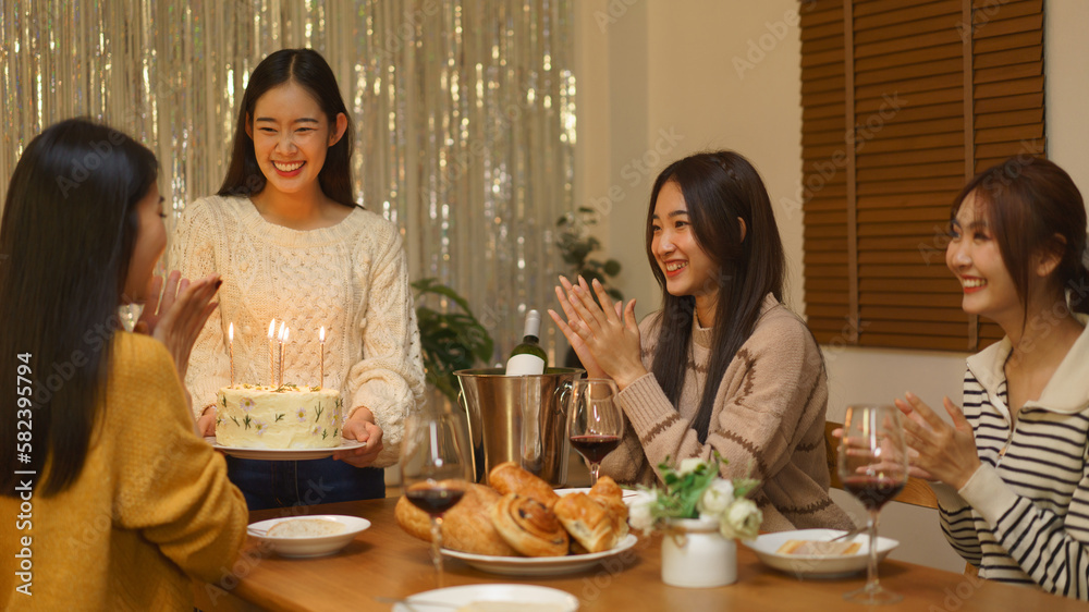 Birthday celebration concept, Asian girls holding birthday cake to surprise friend in party
