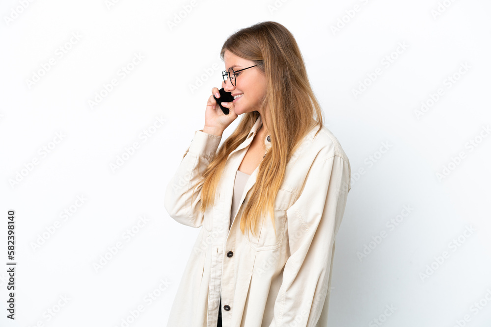 Young blonde woman isolated on white background keeping a conversation with the mobile phone with someone Young blonde woman isolated on white background keeping a conversation with the mobile phone with someone