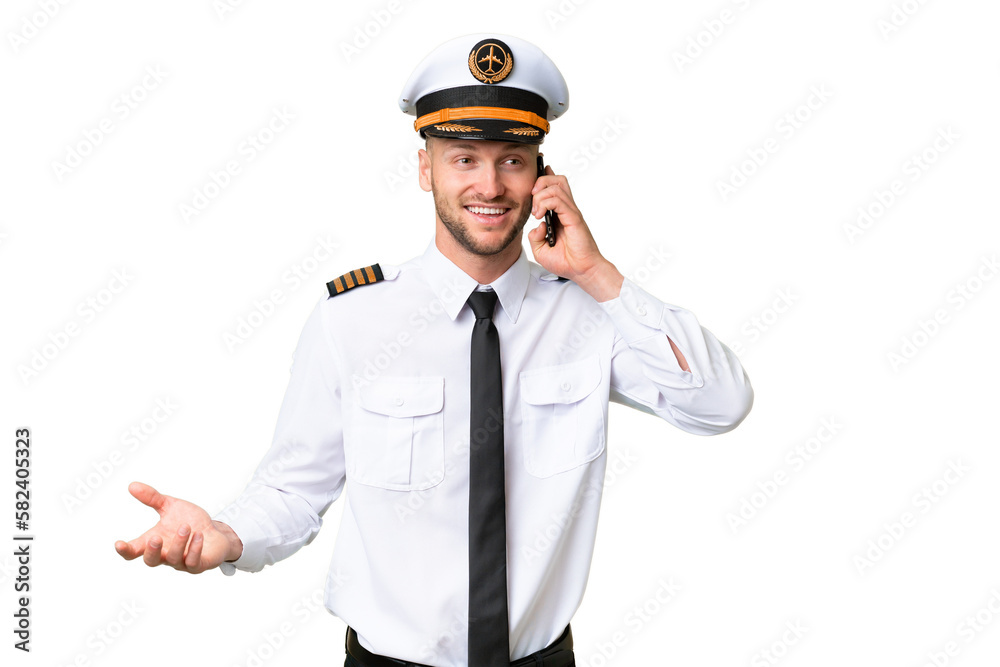 Airplane pilot man over isolated background keeping a conversation with the mobile phone with someone