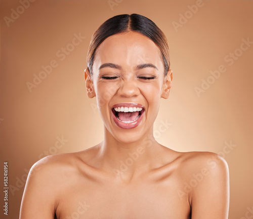 Beauty, face and a woman laughing in studio for skincare with dermatology, cosmetics or makeup. Happy aesthetic female model on a brown background for self care, skin glow and facial wellness