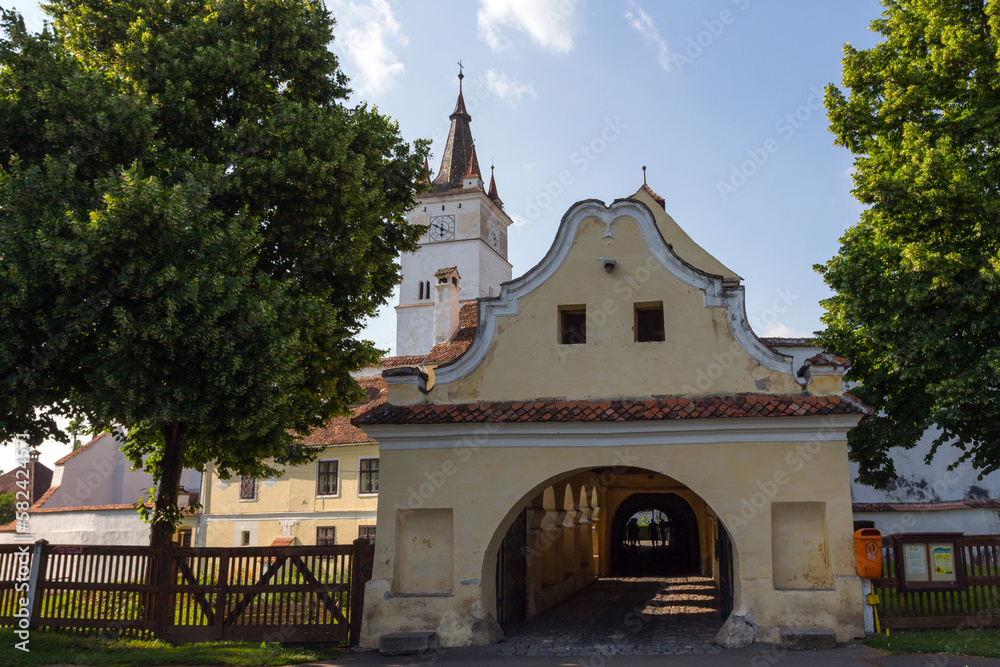 Fototapeta premium The entrance portal of the historical Church-fortress in the city of Harman. Transylvania. Romania
