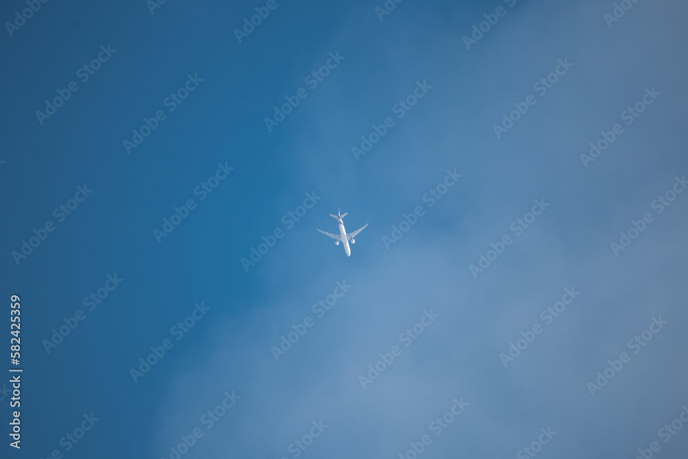 passenger airliner in the blue sky sunny day - flight above the clouds passenger airliner in the blue sky sunny day - flight above the clouds