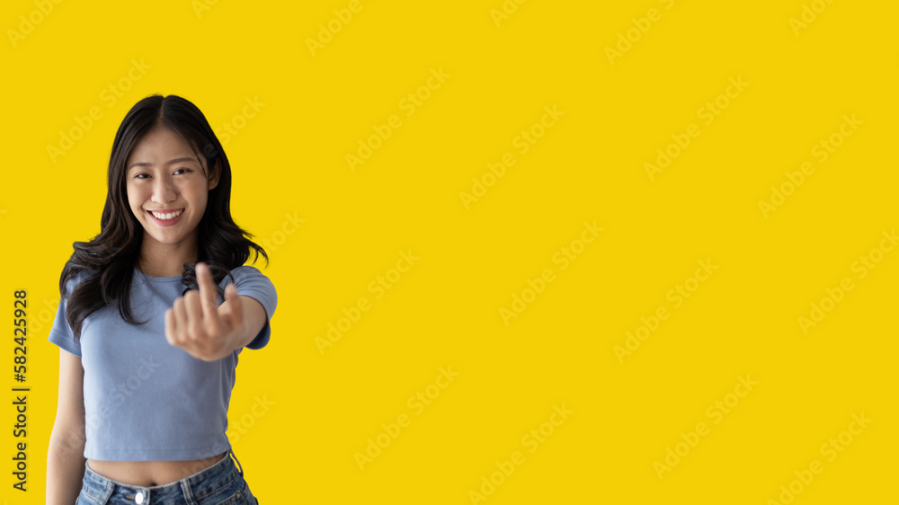 Women beckoning or inviting them to pay attention, Suggest to click or apply with me, Giving assistance and acceptance, Calling with one finger, Come and get me, Woman on yellow background. Women beckoning or inviting them to pay attention, Suggest to click or apply with me, Giving assistance and acceptance, Calling with one finger, Come and get me, Woman on yellow background.