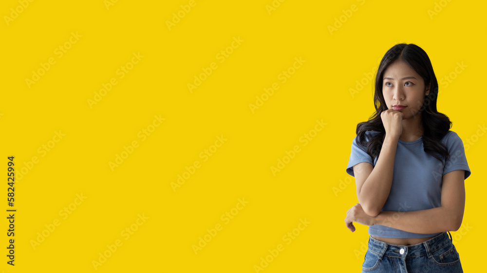 Young Asian woman thinking hard or planning to do something, Overthinking or worrying, Have a headache, Migraine, Stress, Free space for advertising or promoting products, Copy space, Enter text. Young Asian woman thinking hard or planning to do something, Overthinking or worrying, Have a headache, Migraine, Stress, Free space for advertising or promoting products, Copy space, Enter text.