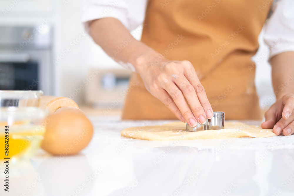 Making for homemade biscuits. On the table is dough and a set of cookie molds with other kitchen equipment. Cute baby cookies in the shape of a heart and a tree. Cooking with baking tools. Making for homemade biscuits. On the table is dough and a set of cookie molds with other kitchen equipment. Cute baby cookies in the shape of a heart and a tree. Cooking with baking tools.