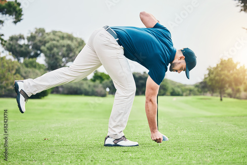 Man, golf ball and tee on grass to ready for game, sport or international competition with focus outdoor. Professional golfer, start and preparation for contest on field, lawn and course in summer