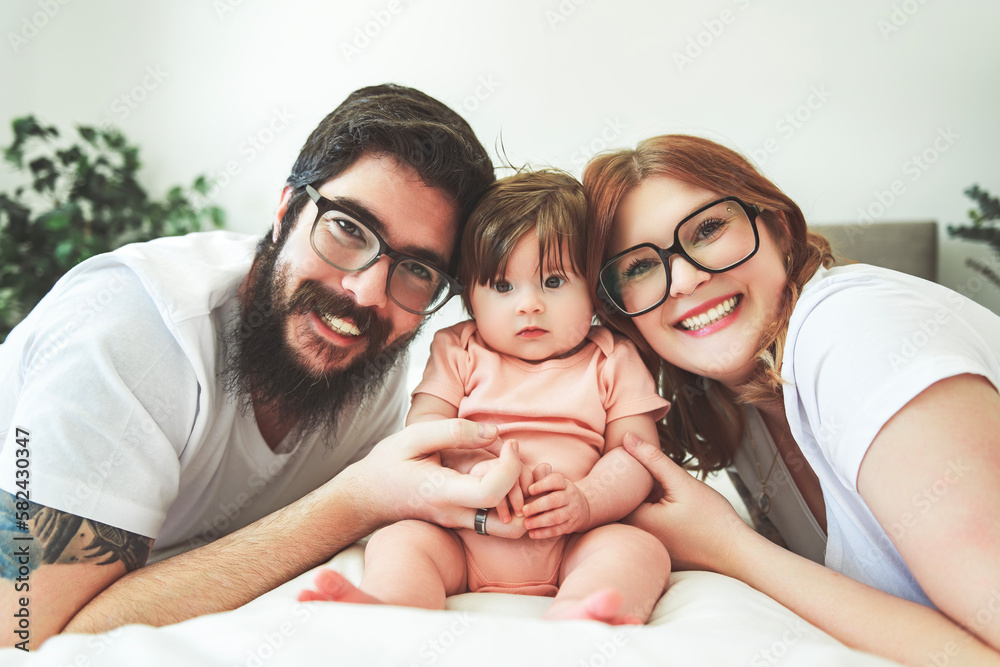 A Portrait of family with her nursing baby on bed A Portrait of family with her nursing baby on bed
