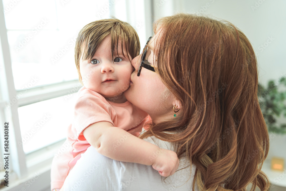 A Portrait of a beautiful mother, with her nursing baby A Portrait of a beautiful mother, with her nursing baby