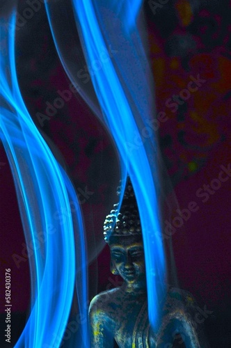 Buddha statue with incense smoke