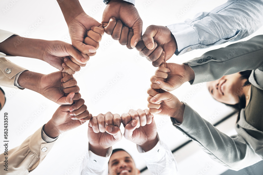 Obraz premium Team building, circle or business people hands in fist for motivation in office meeting together. Diversity, low angle or happy employees with mission, strategy or group support for project planning