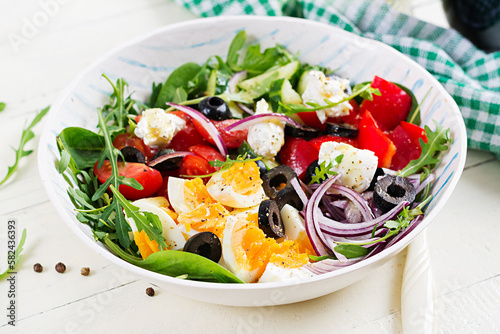 Breakfast. Greek salad and boiled eggs. Fresh vegetable salad with tomato, cucumbers, olives, arugula and cream cheese. Trendy food.