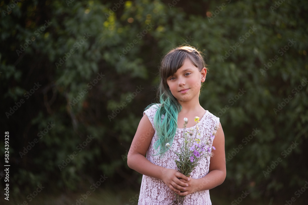 Girl with green hair holds bouquet of wild flowers on botanical background, looks into the camera. Gentle natural gift for mother. Generation Z in bright diversity style. Copy space. Smiling child Girl with green hair holds bouquet of wild flowers on botanical background, looks into the camera. Gentle natural gift for mother. Generation Z in bright diversity style. Copy space. Smiling child