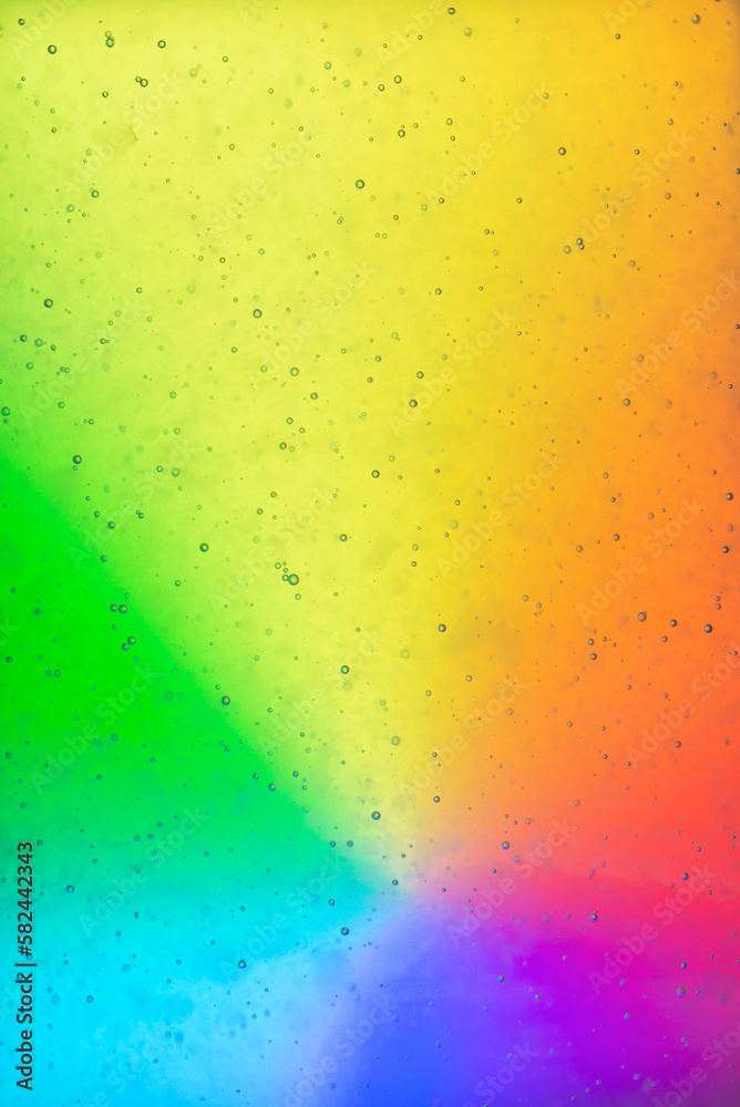 Extream close-up images of water bubbles or soda or liquid texture that splashing and floating up to surface like a explosion in rainbow color background