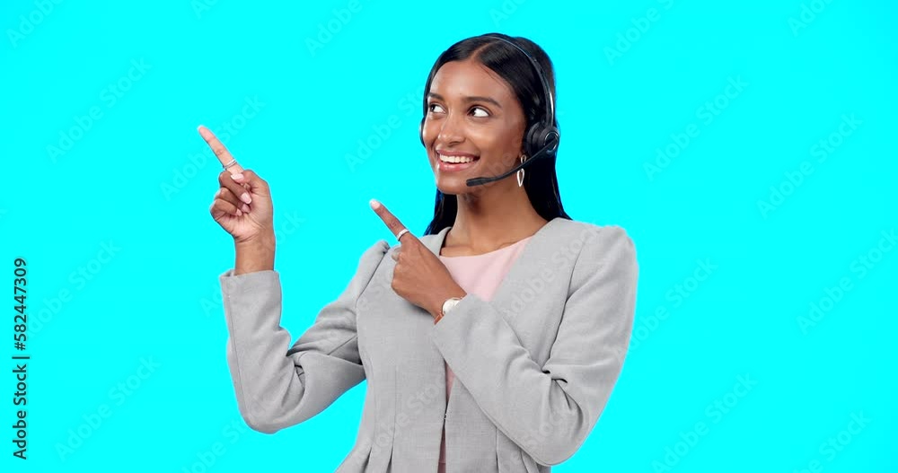 Call center, portrait or Indian woman in studio pointing for promotion or product placement on blue background. Happy smile, mockup space or girl in headset at technical support or customer services Call center, portrait or Indian woman in studio pointing for promotion or product placement on blue background. Happy smile, mockup space or girl in headset at technical support or customer services
