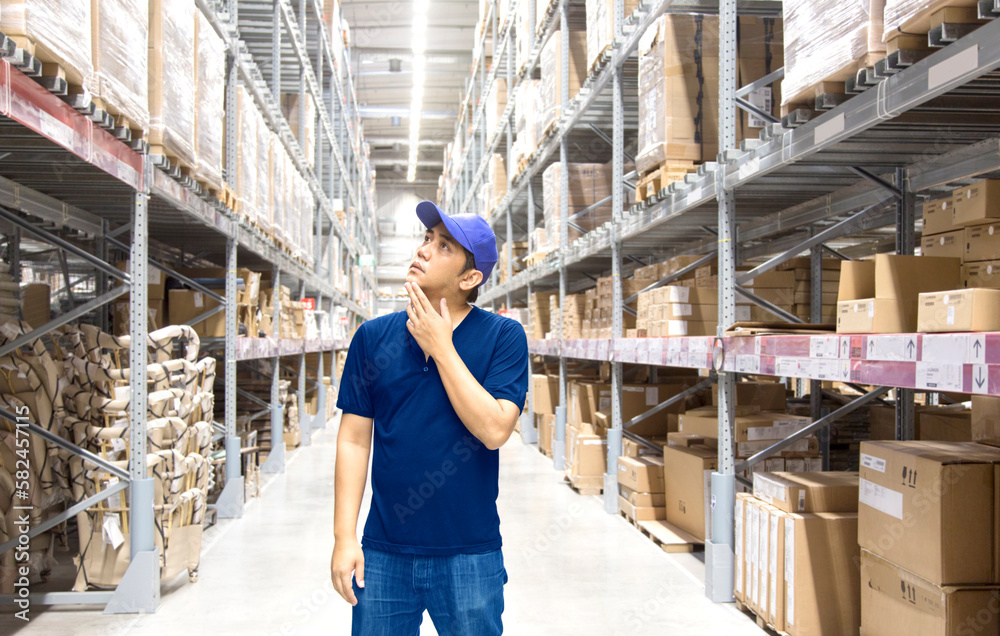 Asian man finding  goods on stock shelves by himself in warehouse in logistic business concept