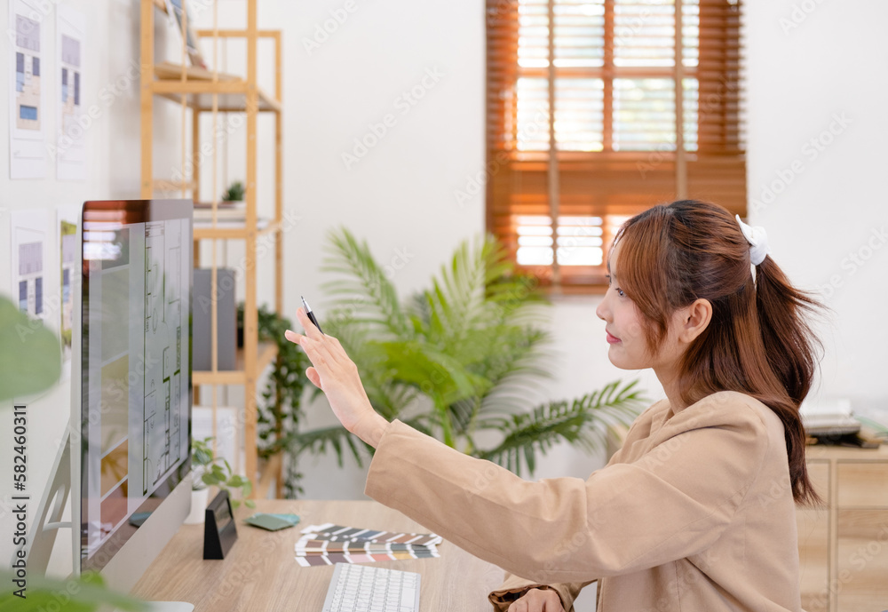 Focused interior designer working at her desk in creative office. Design develop for new interior project. Architecture renovation style design graphic. Focused interior designer working at her desk in creative office. Design develop for new interior project. Architecture renovation style design graphic.