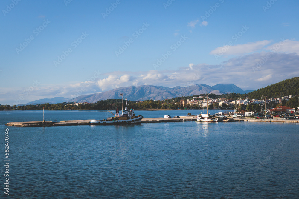 View of Igoumenitsa city harbor, with passenger port, ferry terminal, mountains and Ionian sea, Epirus, Thesprotia, Greece in a summer sunny day with blue sky