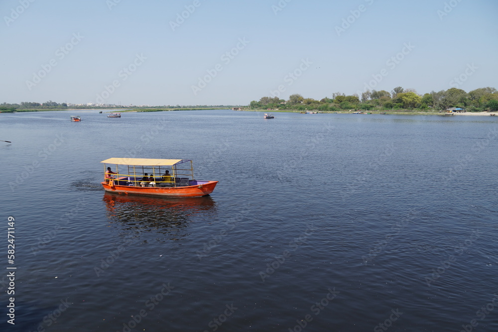 people riding on a boat and enjoying together image yamuna river vrindavan