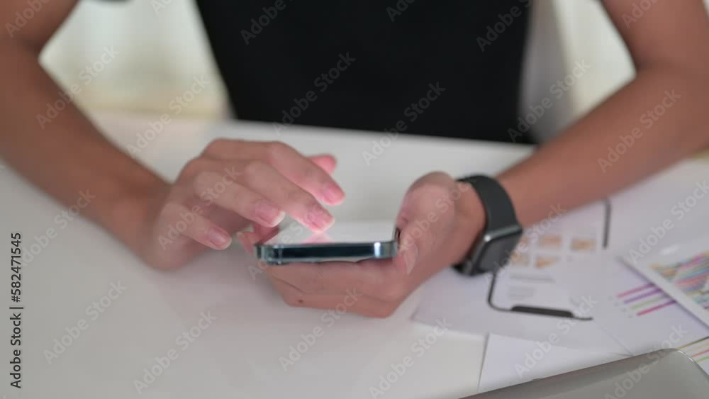 Close up shot of man hands scrolling and messaging on smart phone at working desk Close up shot of man hands scrolling and messaging on smart phone at working desk