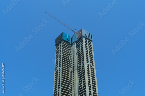 Construction of a multi-storey building. High-rise cranes.