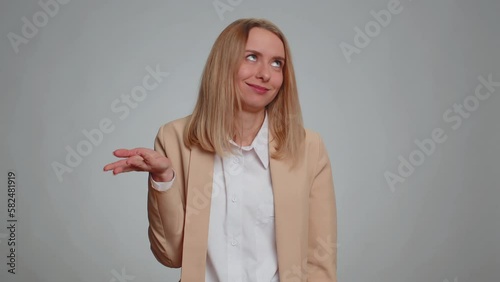 You are crazy, out of mind. Portrait of businesswoman pointing at camera and showing stupid gesture, blaming some idiot for insane plan. Female girl in formal suit. Woman isolated on gray background