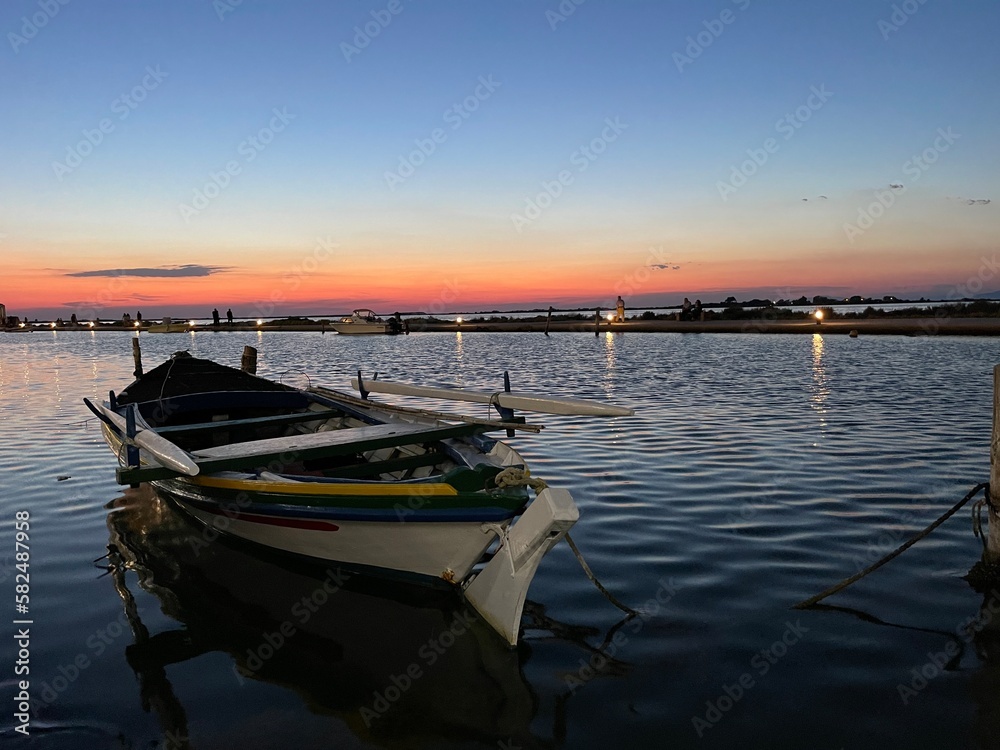Boat in Lefkada harbour in the sunset over the sea