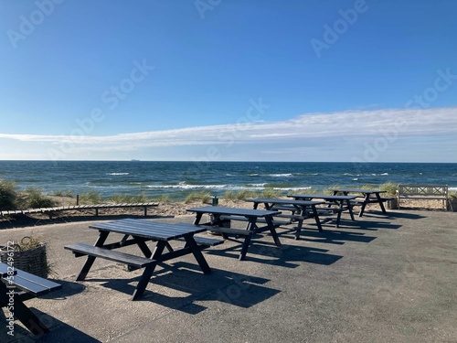 Tables on the coast overlooking the beautiful seascape on a sunny day