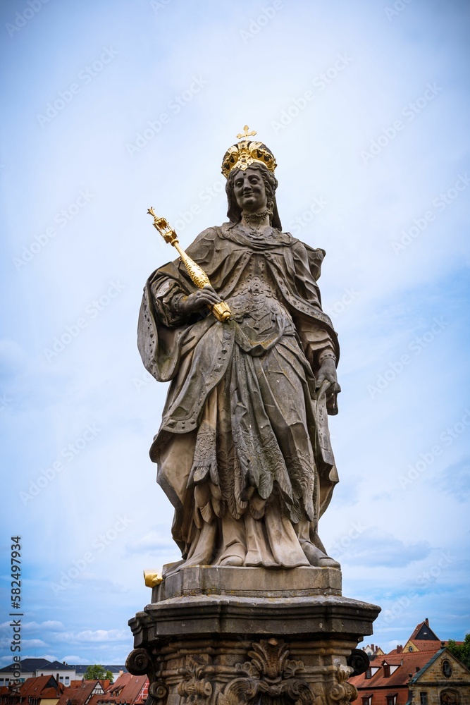 Vertical shot of the statue of St. Kunigunde in the old Bamberg town against the blue sky